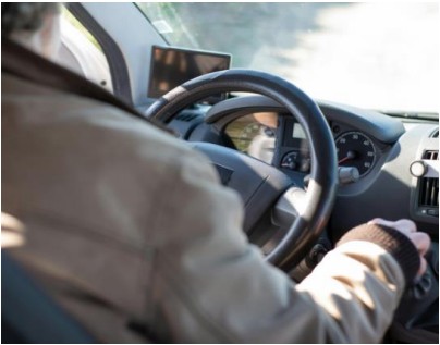 Image taken from the back seat of a car of the driver.