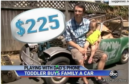 News image of toddler sitting on father's lap on the fender of a nonworking car. Purchased by accident by the toddler for 225 dollars.