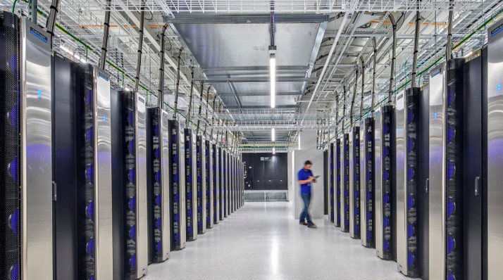 Single man in a row of a data center.